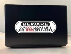 10in x 3in Dog Looks Cute Bites Strangers Vinyl Sticker